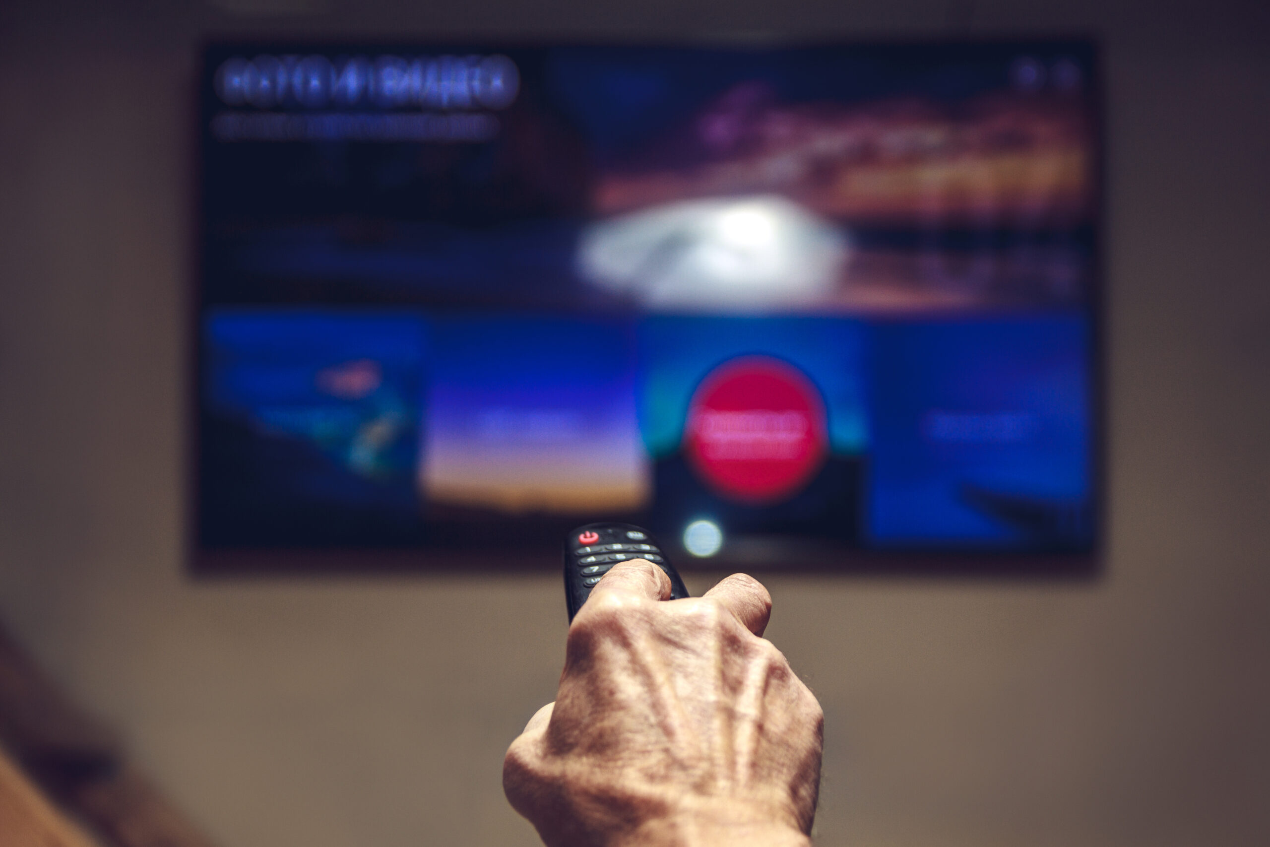 TV remote control in the hands of an elderly man tucci eat and walk eataly