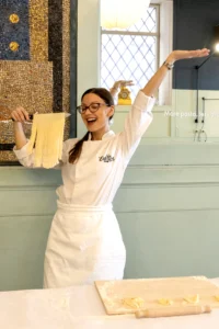 italian chef showing freshly made fettuccine during the best cooking class in Rome