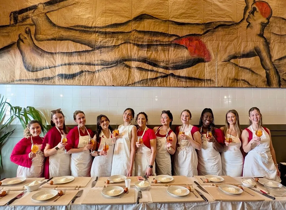 Team celebrating with spritz during a cooking experience in Rome
